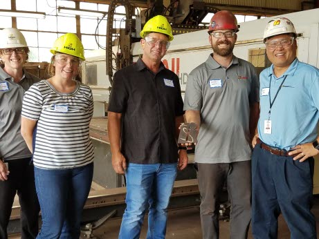 Teachers Bridget Hutchinson (second from left) and Douglas Long (center) paused during their tour of High Steel Structures LLC with Renee Entsminger (far left), Asher Vencil (second from right), and Don Lee (far right).